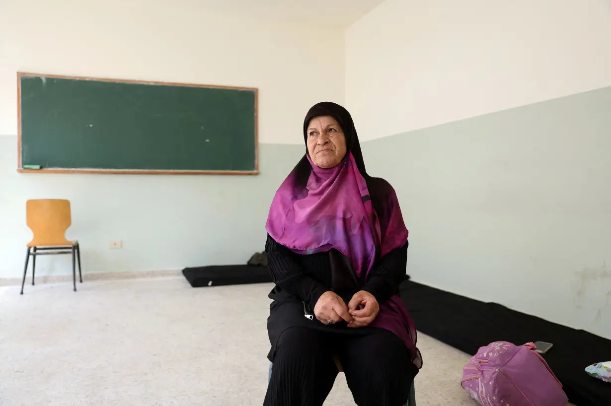 Souad mahde, 63, sits in a class room at the Technical Institute of Bir Hassan turned into a shelter in Beirut