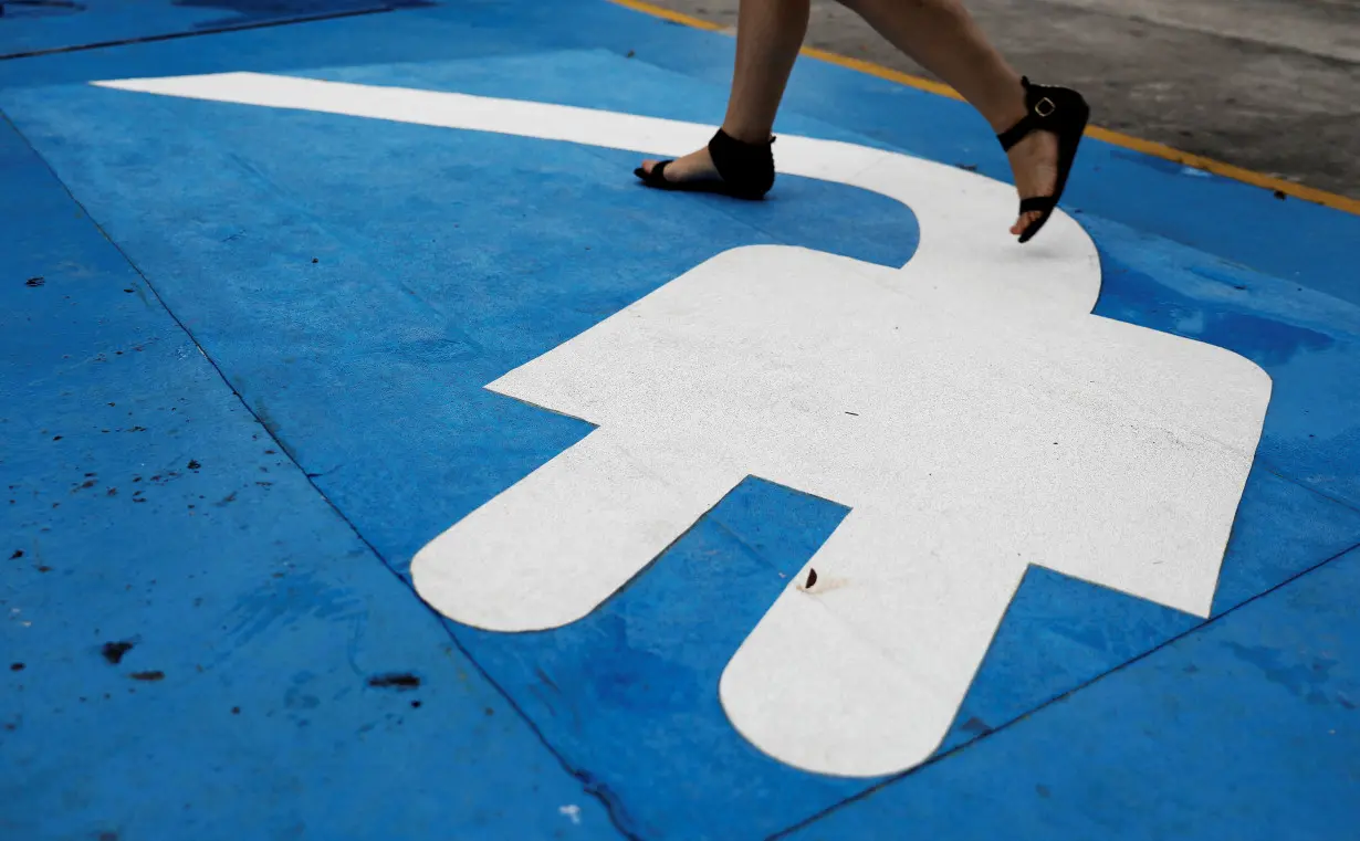 FILE PHOTO: Electric car charging sign is seen in a car park at a petrol station in Sao Paulo