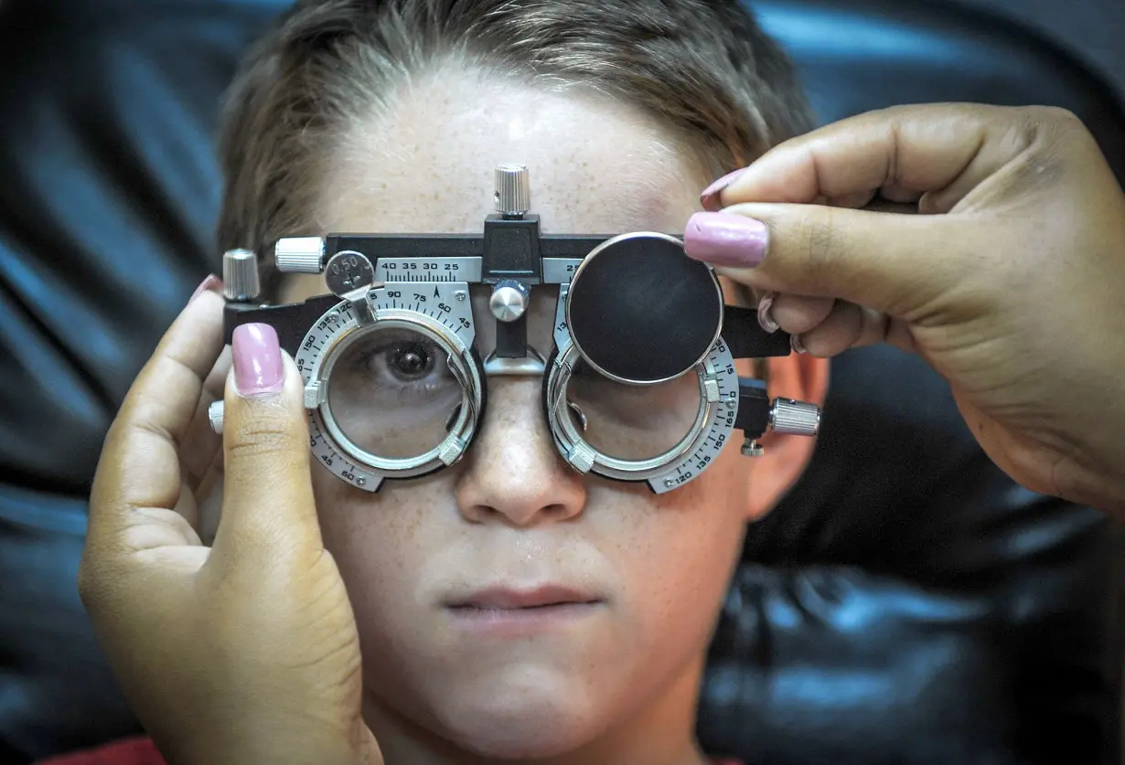 An optometrist tests a child's vision.