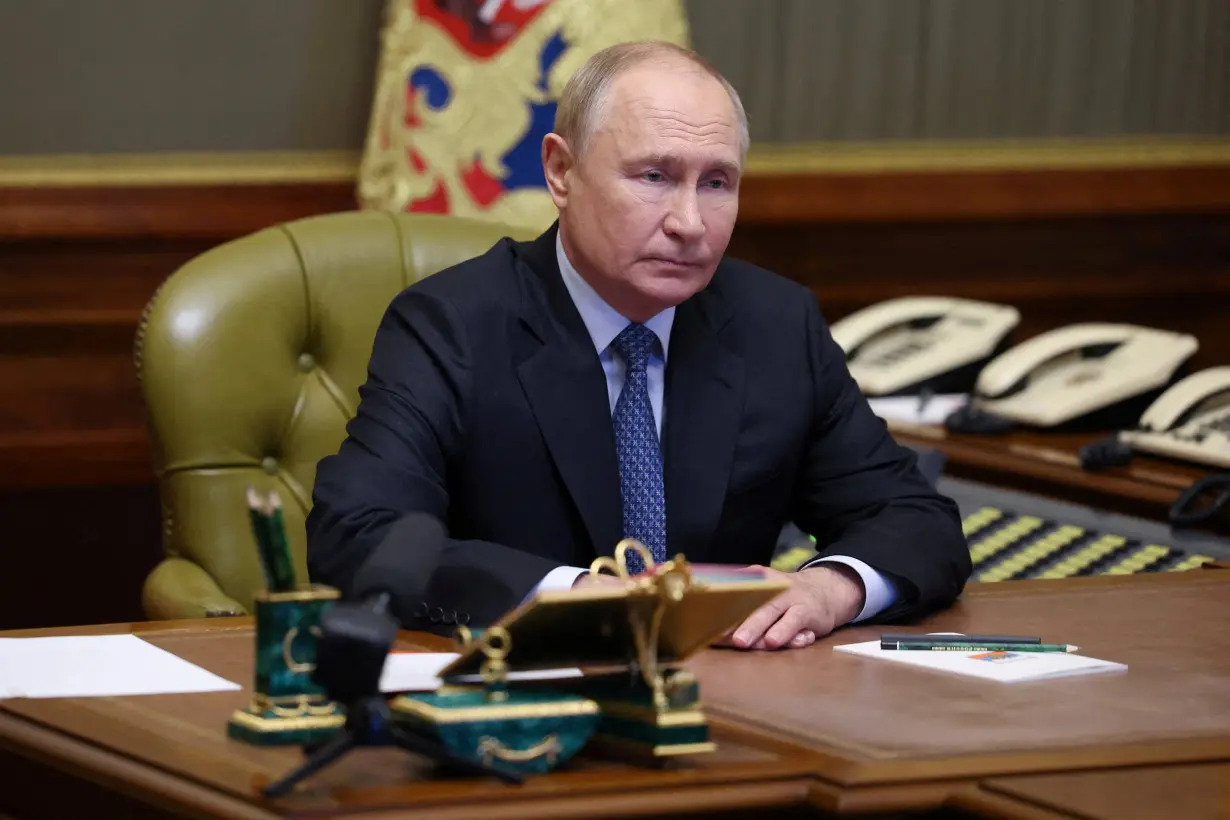 Russian President Putin chairs a meeting with members of the Security Council via video link in Strelna