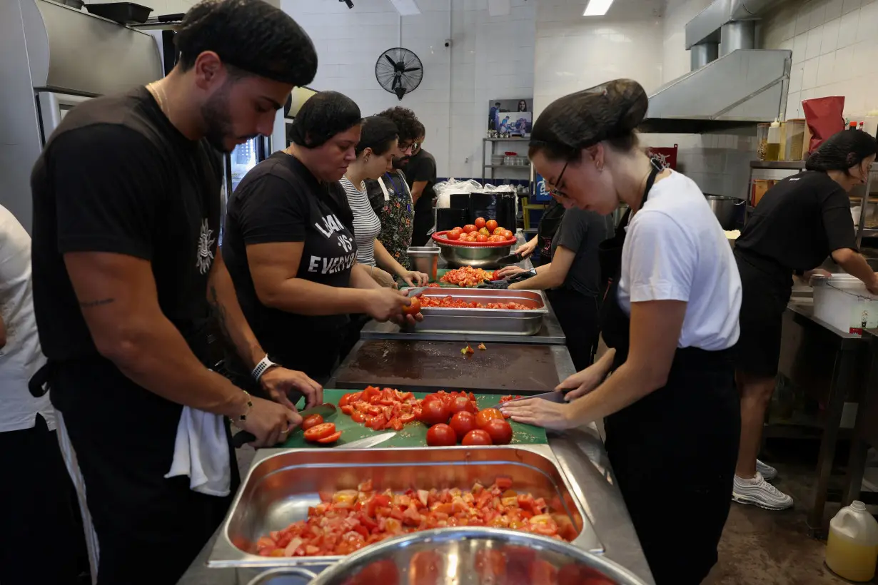 Volunteers prepare meals to be distributed for displaced people, in Beirut