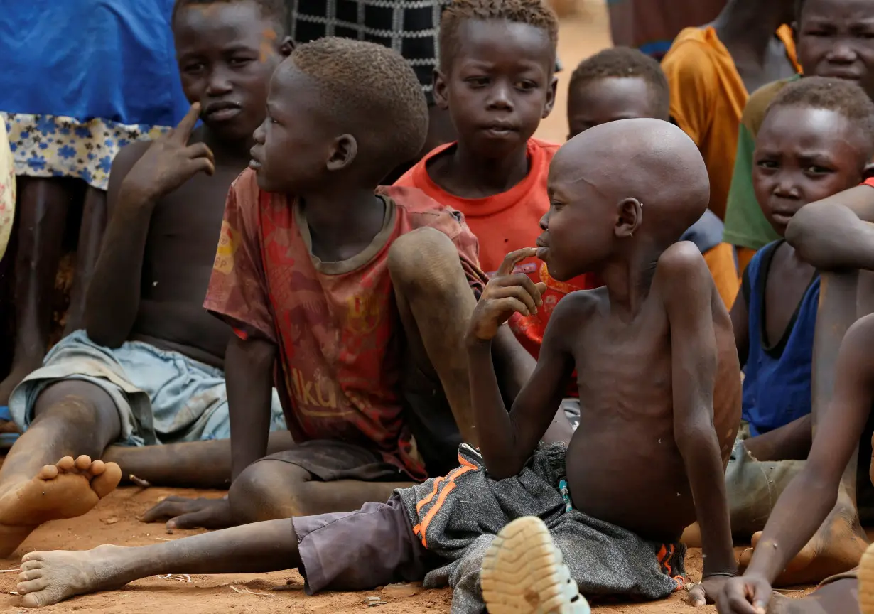 Children wait to eat boiled leaves at IDP Camp in South Kordofan, Sudan