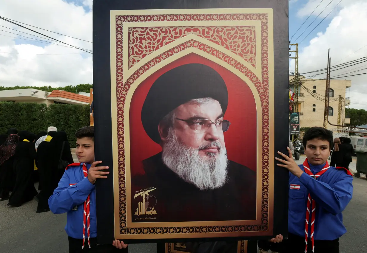 FILE PHOTO: Boys scouts carry a picture of Hezbollah leader Sayyed Hassan Nasrallah in Kfar Melki