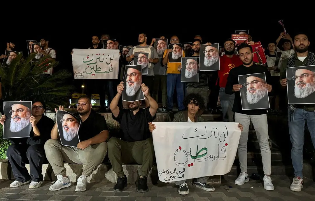 Supporters of Lebanon's Hezbollah leader Sayyed Hassan Nasrallah carry his pictures as they gather in Sidon