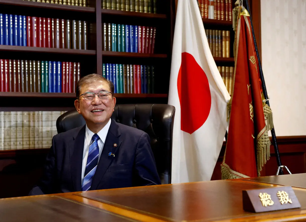 FILE PHOTO: Shigeru Ishiba, the newly elected leader of Japan's ruling party, the Liberal Democratic Party (LDP) poses in the party leader's office after the LDP leadership election, in Tokyo