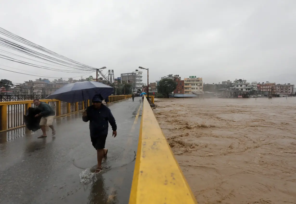 FILE PHOTO: Flood along the bank of overflowing Bagmati River following heavy rains in Kathmandu