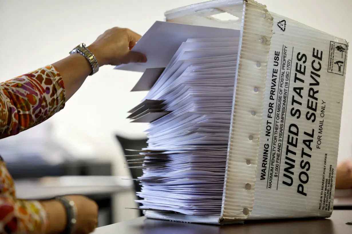 FILE PHOTO: Election worker prepares absentee ballots in Raleigh