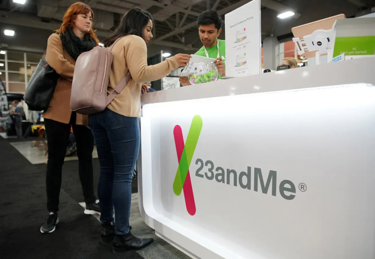 FILE PHOTO: Attendees purchase DNA kits at the 23andMe booth at the RootsTech annual genealogical event in Salt Lake City