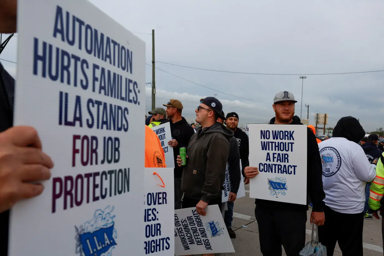 Members of the International Longshoremen's Association union stand outside Columbia Container Services on strike in Elizabeth, New Jersey