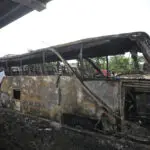 Thai police arrest driver and work to identify victims of the school bus fire that killed 23