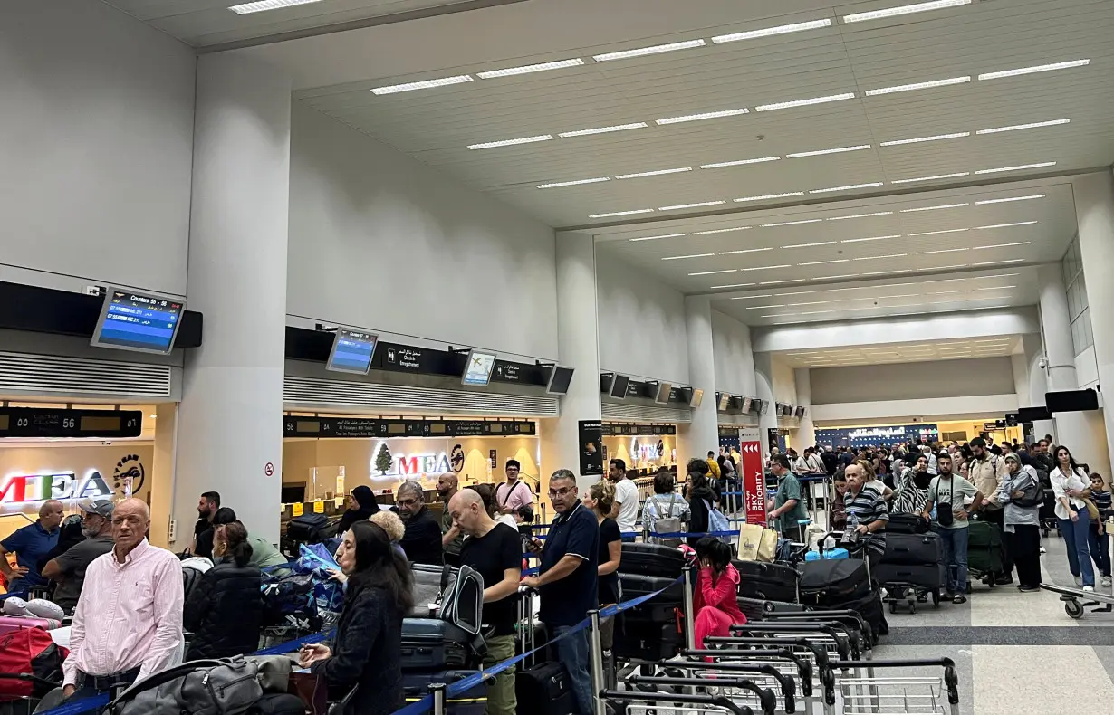 Passengers queue at the check-in counters at Beirut-Rafic Al Hariri International Airport