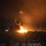 Israeli airstrikes rock southern suburbs of Beirut and cut off a key crossing into Syria