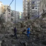 Israeli airstrikes rock southern suburbs of Beirut and cut off a key crossing into Syria