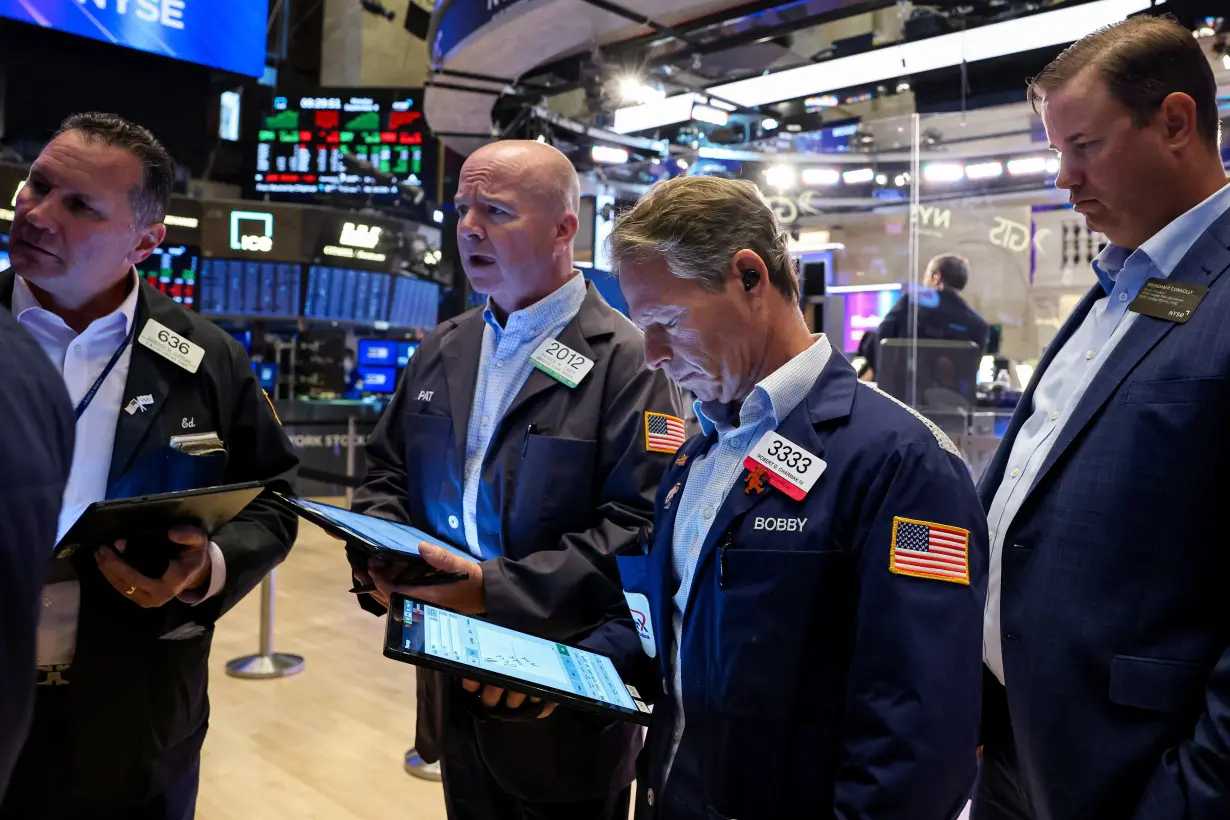 Traders work on the floor of the NYSE in New York