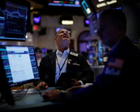 Dow registers record high close as US jobs data eases economic worries