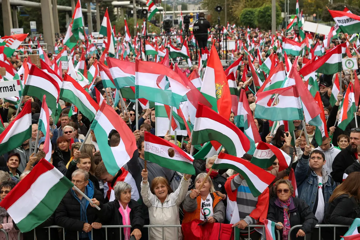 People attend a protest organized by the leading opposition party TISZA, at the public TV building in Budapest