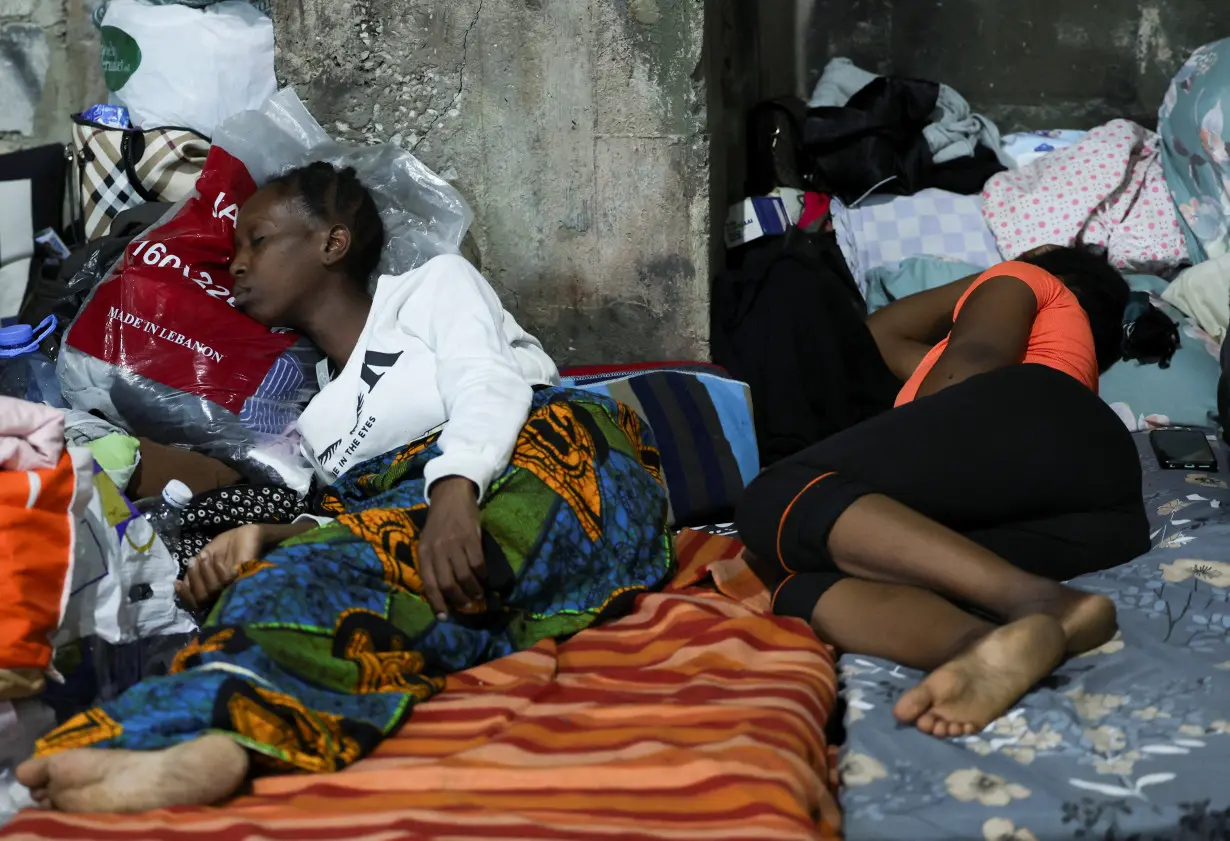 Two women from Sierra Leone sleep on a mattress at a shelter for displaced migrant workers in Hazmieh,