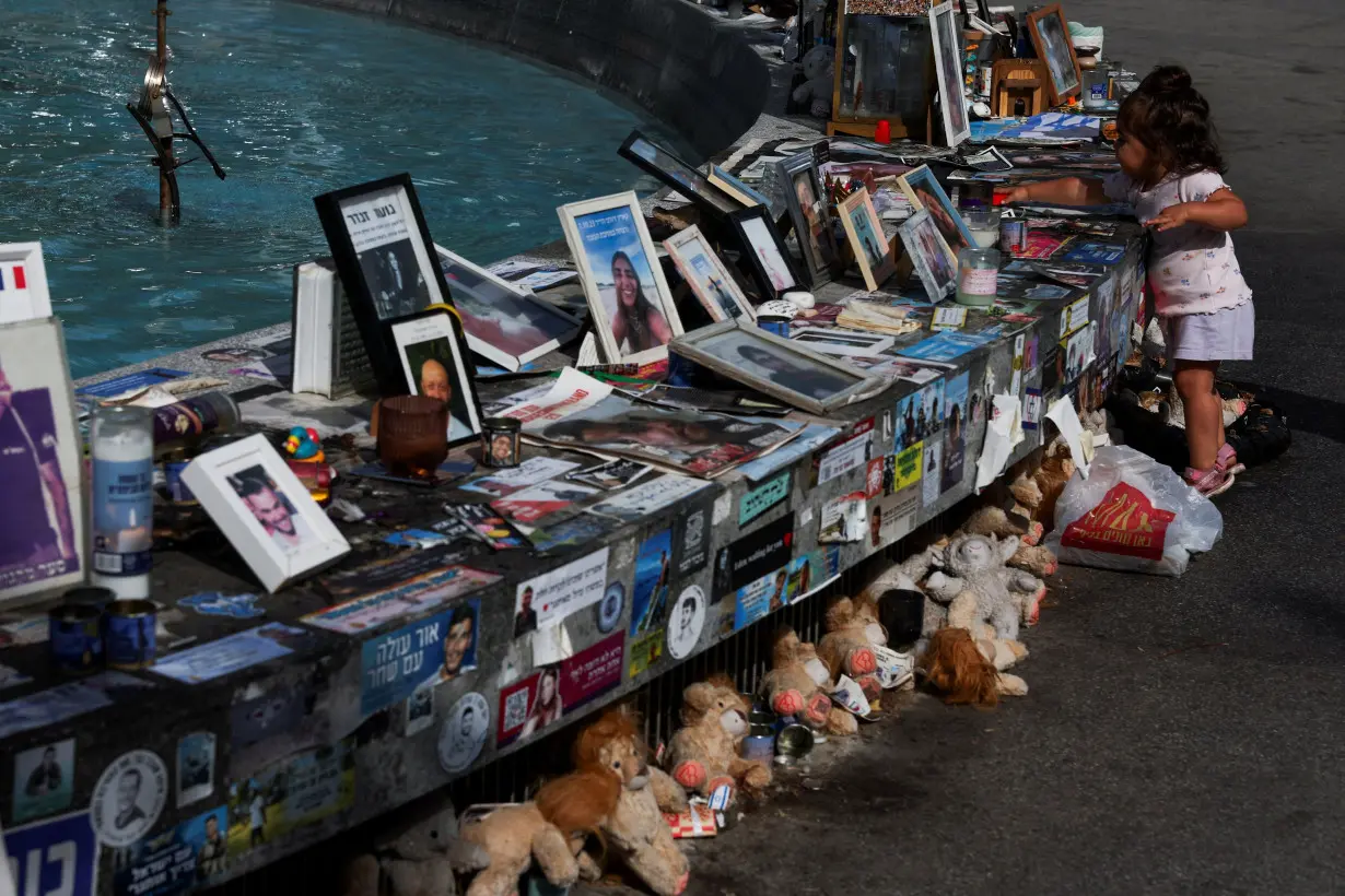 FILE PHOTO: A child stands next to memorials for hostages, in Tel Aviv