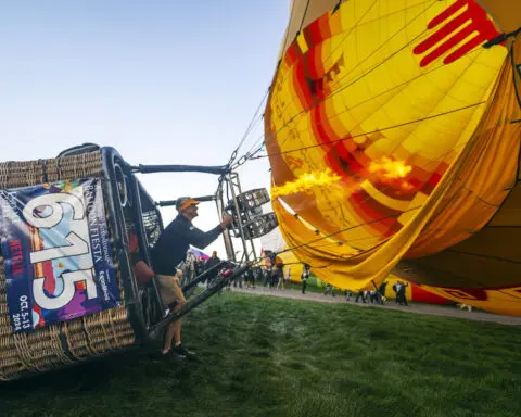 'Magical' flotilla of hot air balloons take flight at international fiesta amid warm temperatures