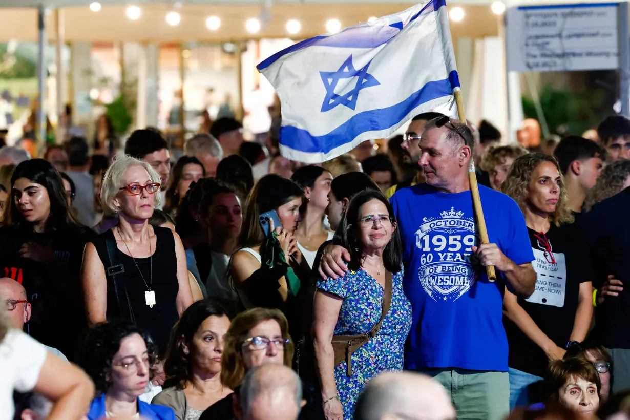 A man holding an Israel flag attends a gathering to support hostages kidnapped during the deadly October 7 attack on Israel by Hamas, in Tel Aviv