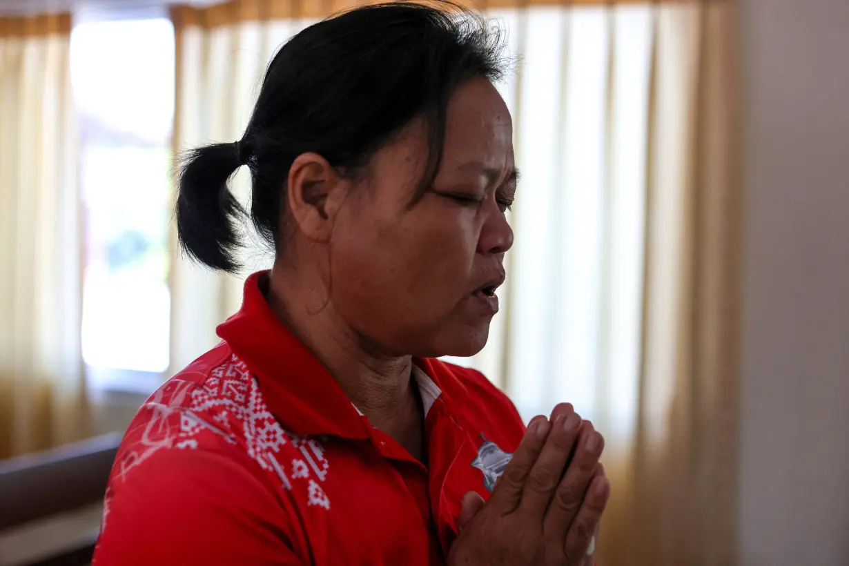 Wiwwaro Sriaoun, mother of a remaining Thai hostage captured by Hamas, Watchara Sriaoun, attends Sunday church service, in Kut Yang village, Udon Thani province