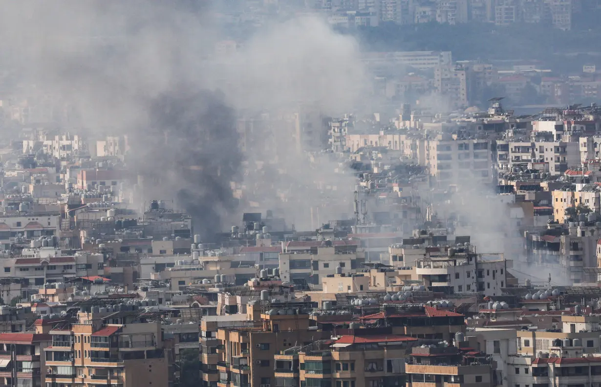 Smoke rises over Dahiyeh in Beirut's southern suburbs, as seen from Sin El Fil