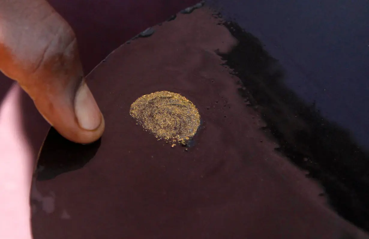 A prospector sorts gold particles found at the Marco gold mine in Mukungwe locality in Walungu territory of South Kivu