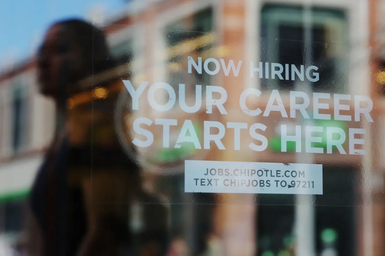 A Chipotle restaurant advertises it is hiring in Cambridge, MA