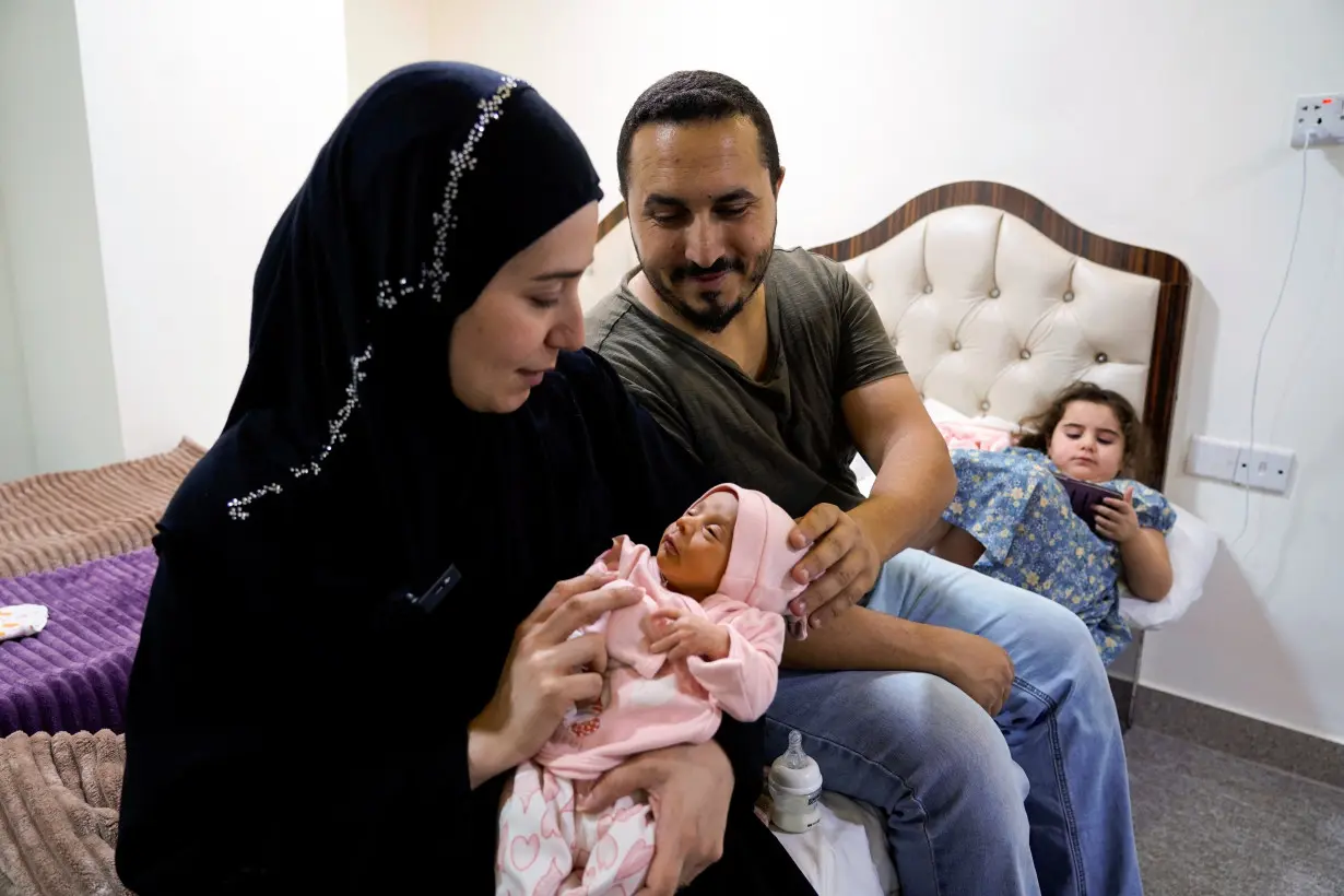 Lubana Ismail, a displaced Lebanese woman holds her newborn baby girl, to whom she gave birth in Iraq, in Najaf