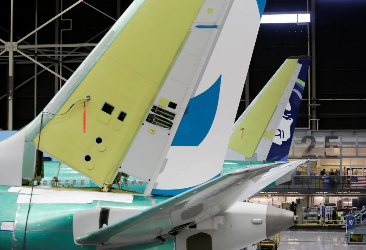 The tail of Boeing's new 737 MAX-9 is pictured next to an older model under construction at their production facility in Renton, Washington