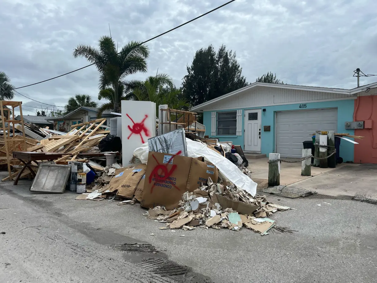 Storm debris from Hurricane Helene sits Tuesday in Anna Maria Island, Florida.