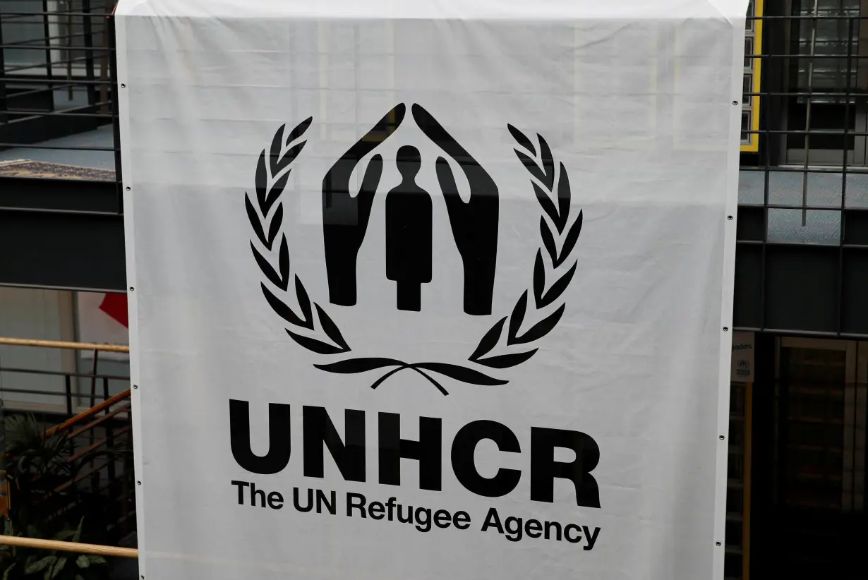 FILE PHOTO: A logo is pictured on a banner at the UNHCR headquarters in Geneva