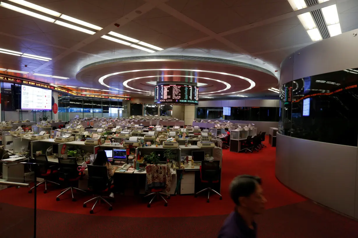 A floor trader walks during afternoon trading at the Hong Kong Stock Exchange in Hong Kong