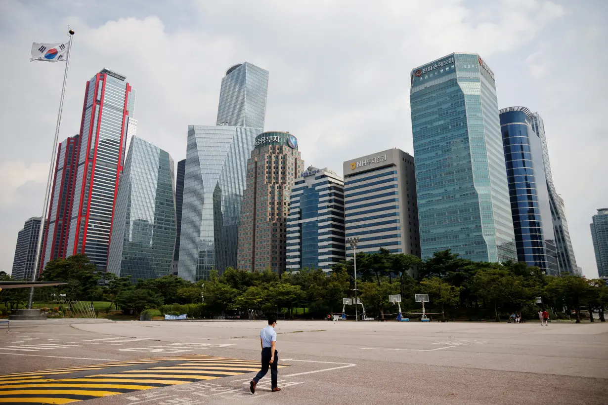 An employee walks at an empty park near a financial district amid the coronavirus disease (COVID-19) pandemic in Seoul