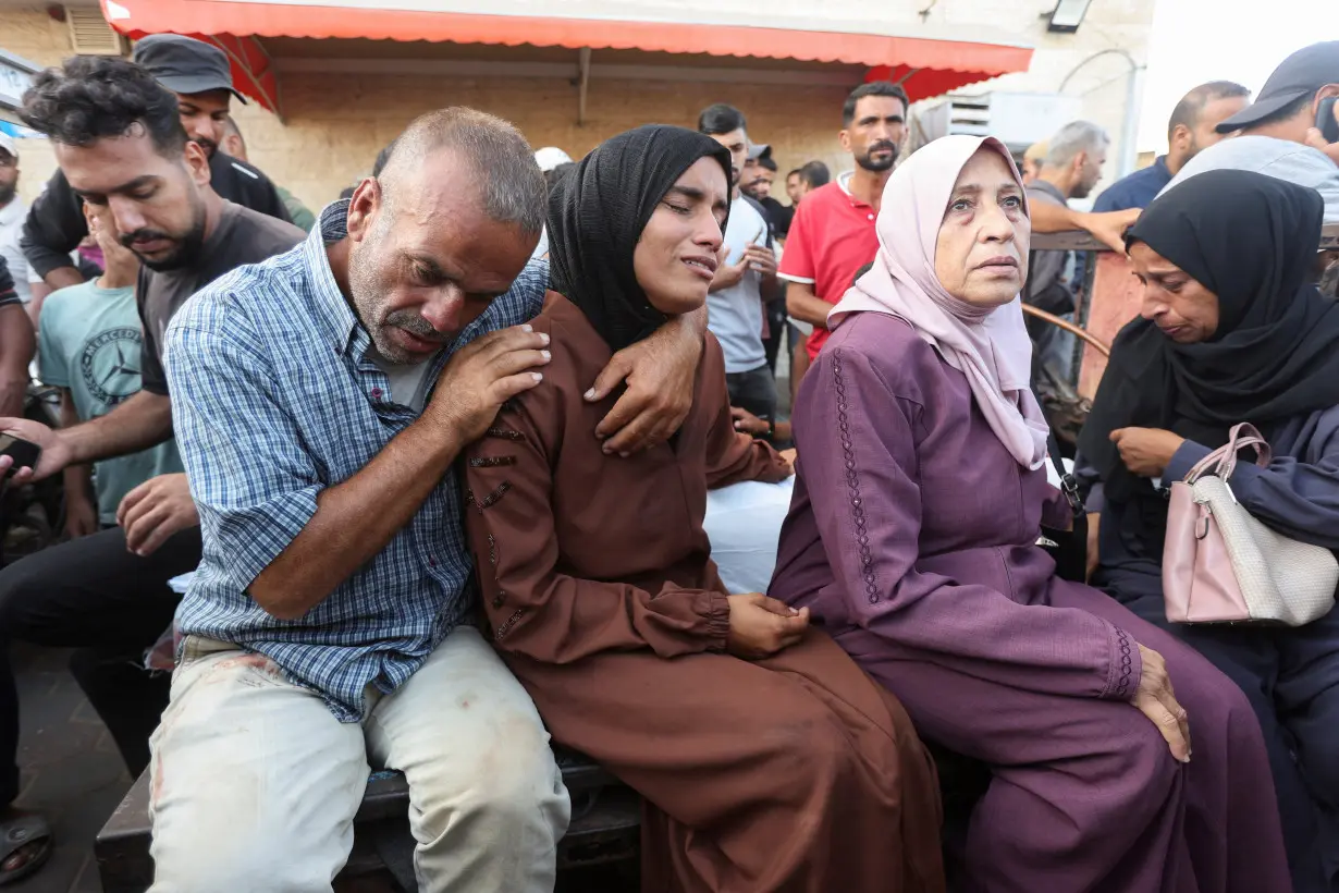 Palestinians mourn loved ones killed in Israeli strikes, in Deir Al-Balah in the central Gaza Strip