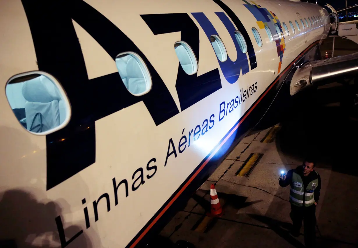 FILE PHOTO: An employee of Azul Brazilian Airlines checks the Embraer 190 plane at International Airport in Guarulhos