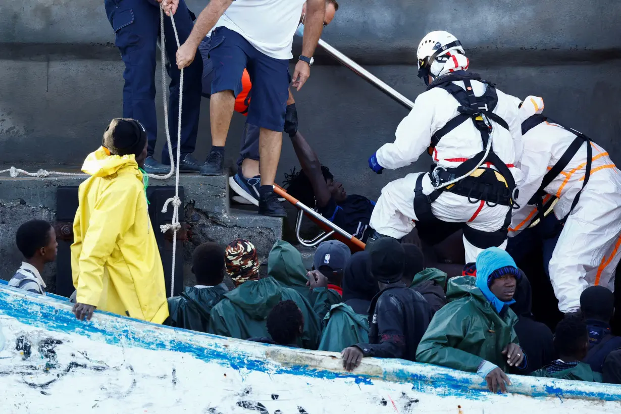 FILE PHOTO: Rescuers disembark a migrant in serious health condition at the port of La Restinga on the island of El Hierro