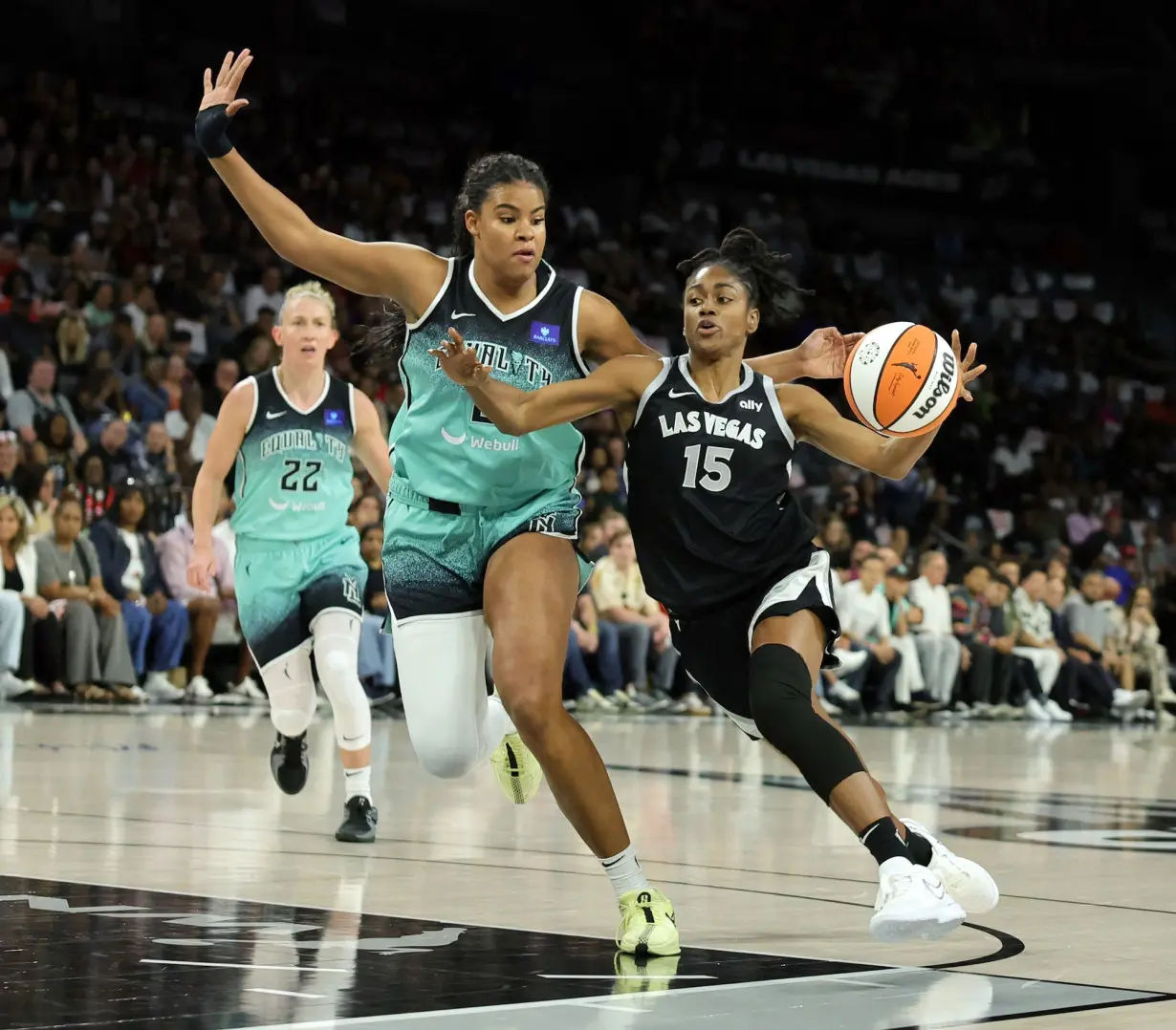 Tiffany Hayes (No. 15) of the Las Vegas Aces battles the New York Liberty's Nyara Sabally to the hoop during the 2024 WNBA Playoffs.