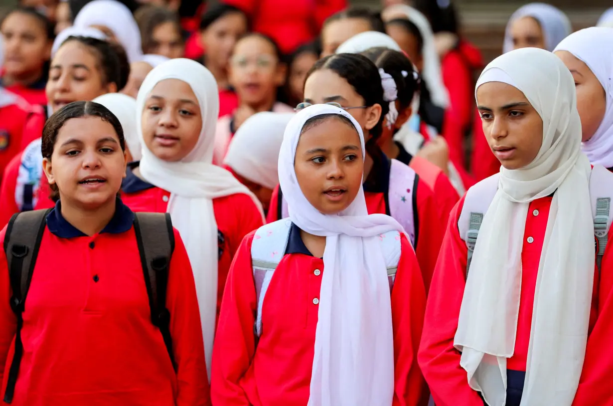 Students line up on the first day of the academic year at Orman school, in Cairo