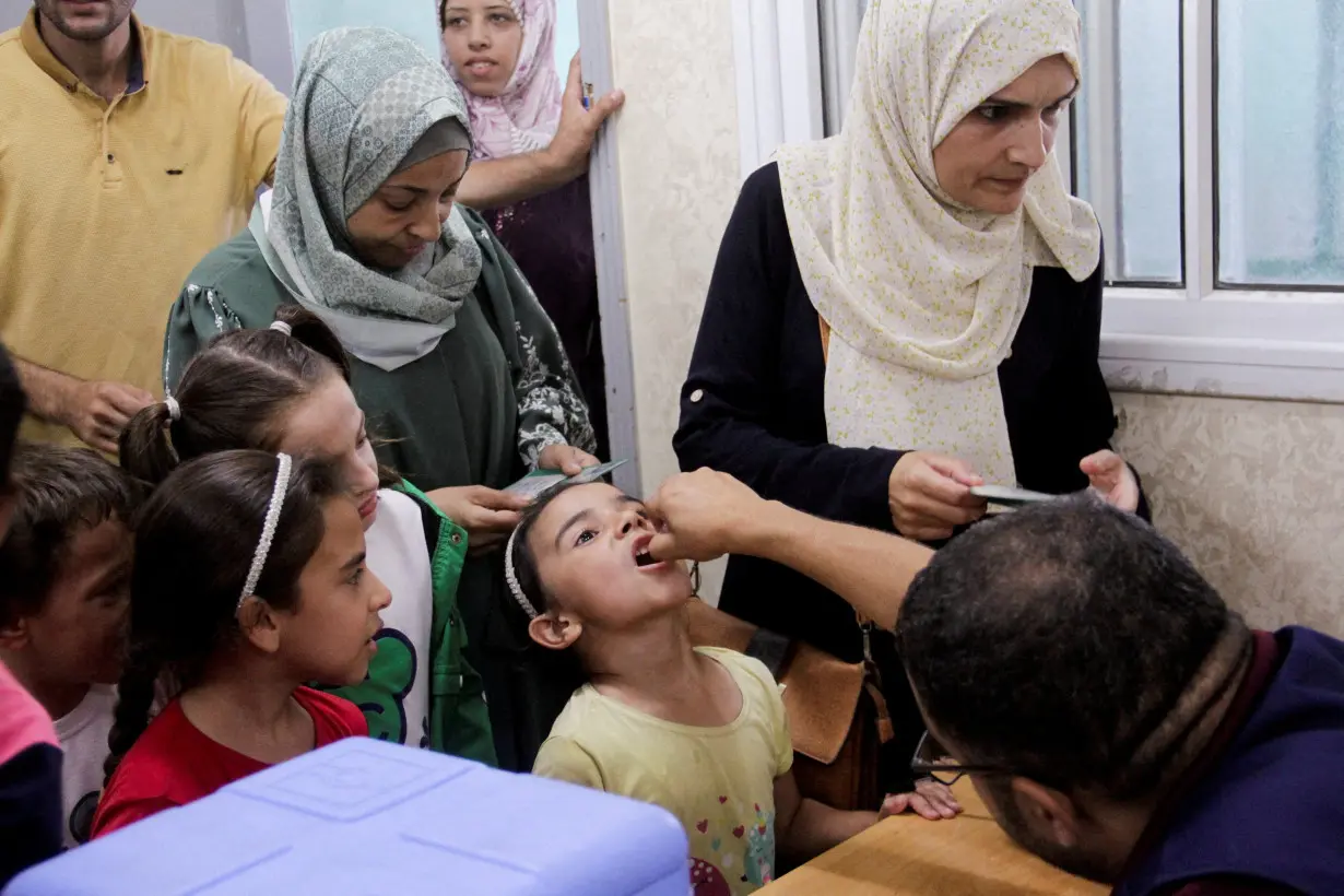 FILE PHOTO: Palestinian children are vaccinated against polio, in Jabalia