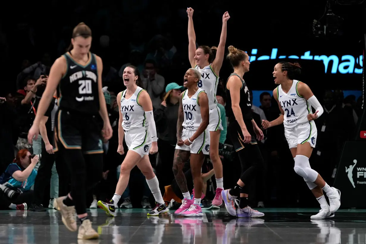 Minnesota Lynx players celebrate after defeating the New York Liberty in overtime in Game 1 of the WNBA Finals.