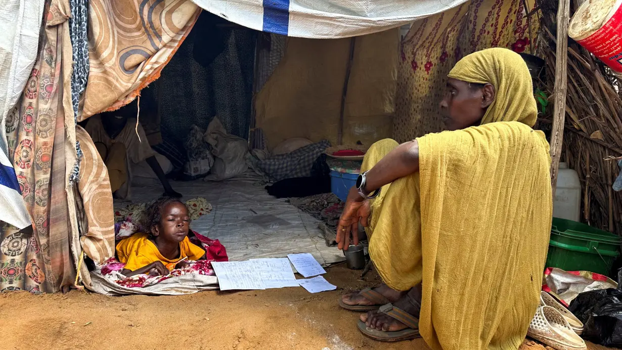 FILE PHOTO: Displaced Sudanese woman rests inside a shelter at Zamzam camp, in North Darfur