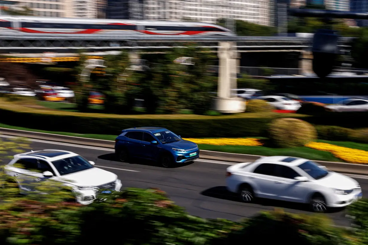 FILE PHOTO: BYD's electric vehicle (EV) Yuan Plus moves on a street in Beijing