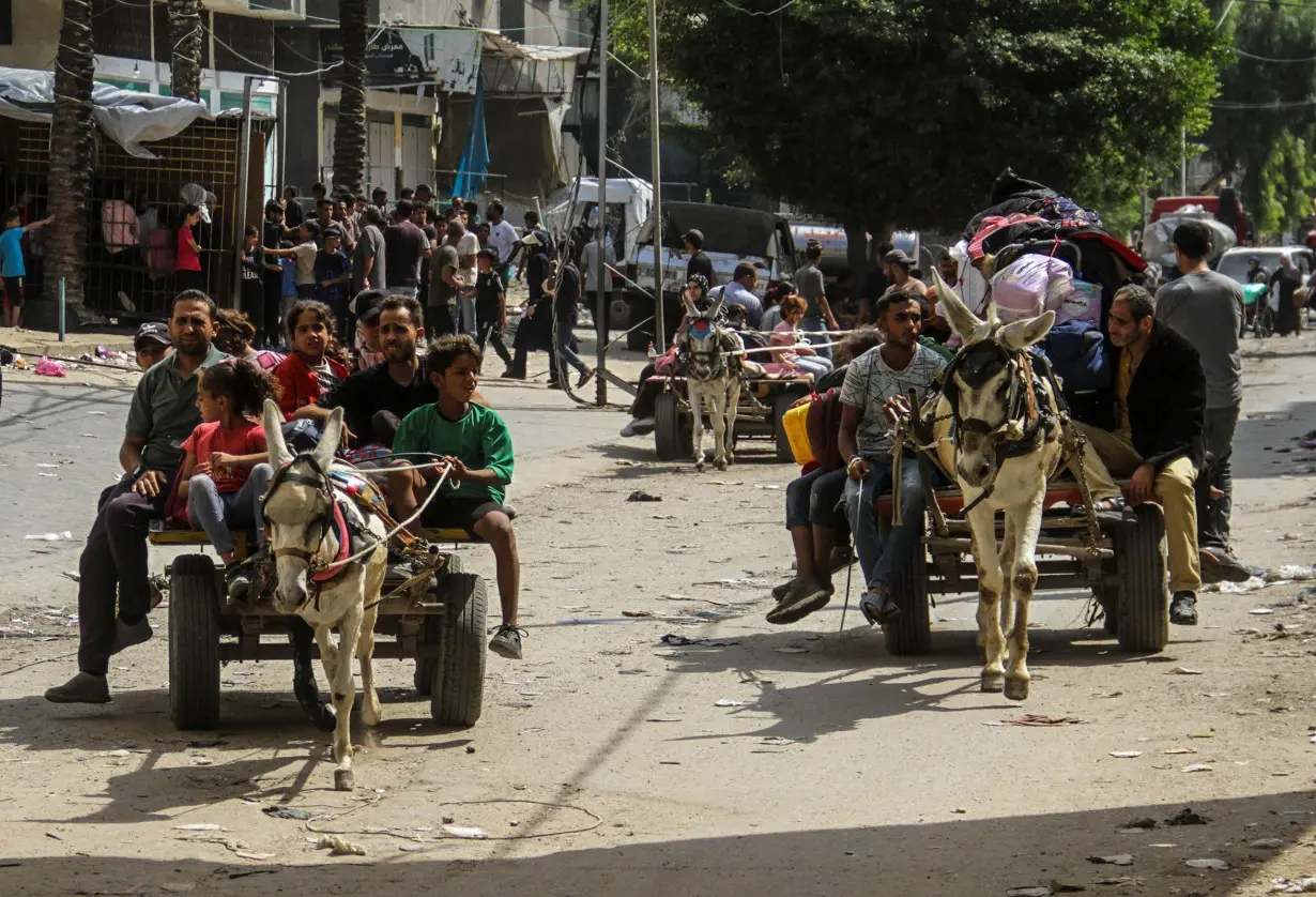 Palestinians flee with the few belongings they can carry following an Israeli attack on Jabalya camp on October 8.