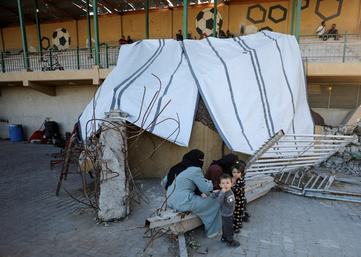 Displaced Palestinians take shelter in a stadium, in Gaza City