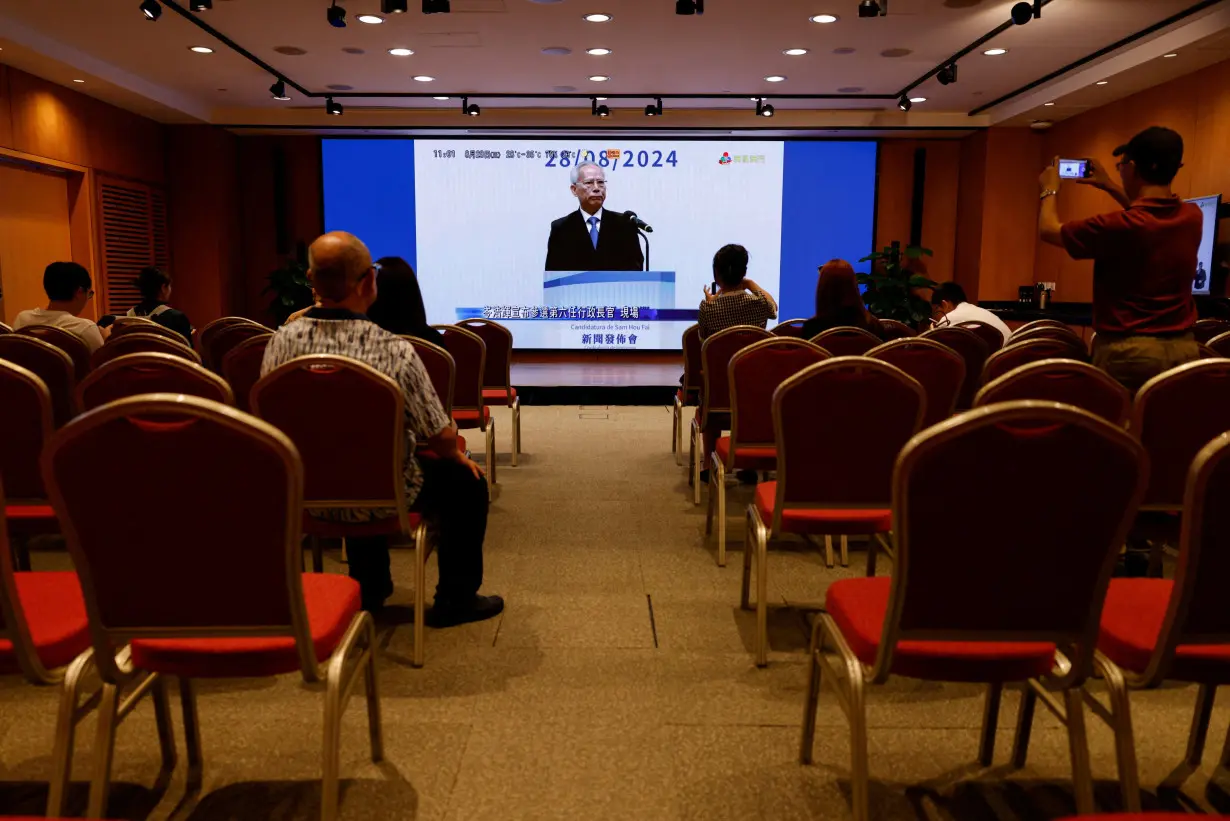 Former president of Macau's Court of Final Appeal, Sam Hou-fai, is seen on a screen as he announces his candidacy for Macau's sixth-term Chief Executive election, in Macau