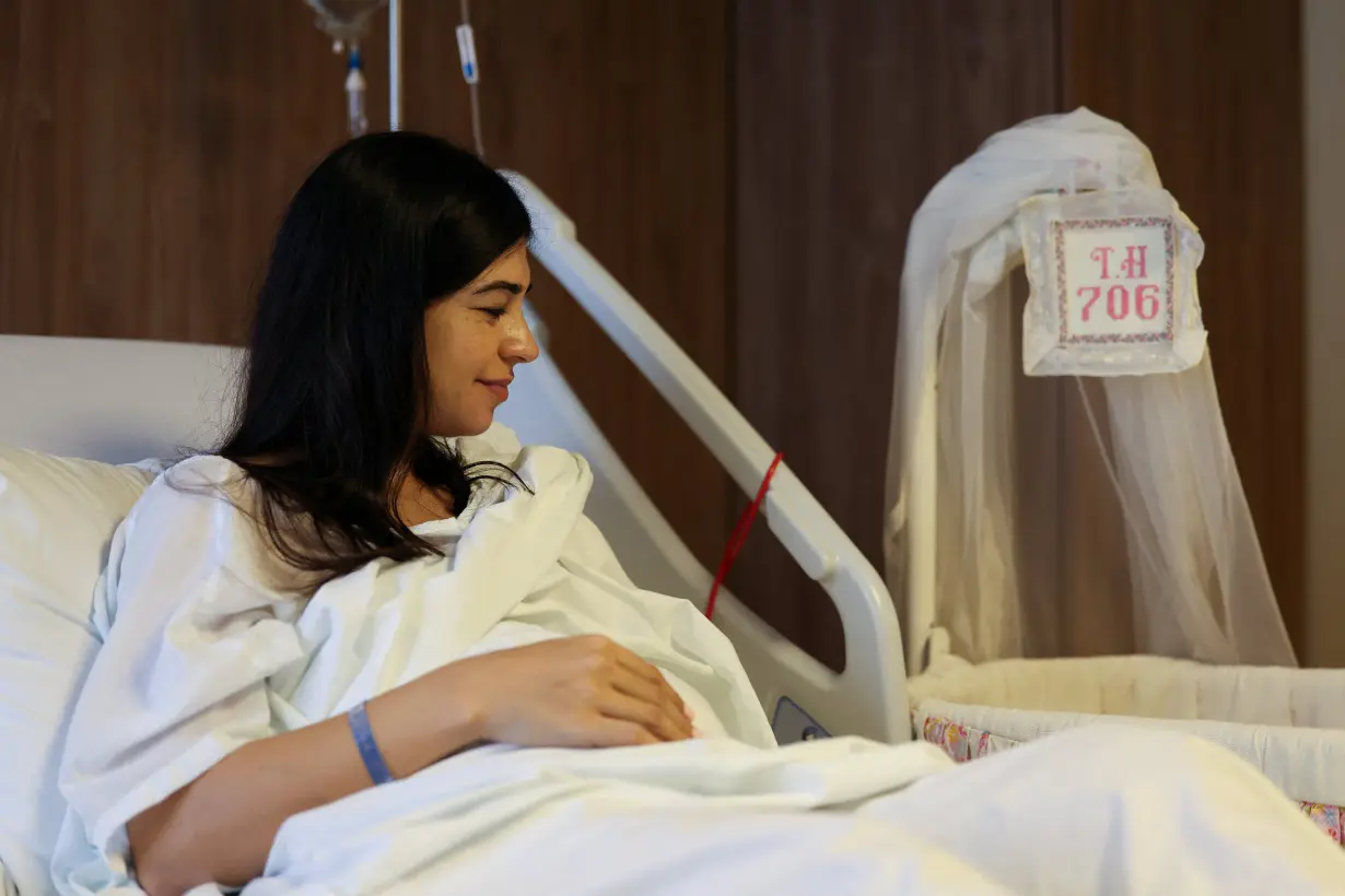 Tahani Yassine looks at her newborn at Trad hospital in Beirut