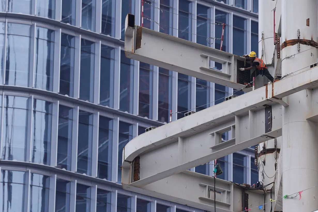 Worker works on a building under construction in Beijing's Central Business District (CBD)