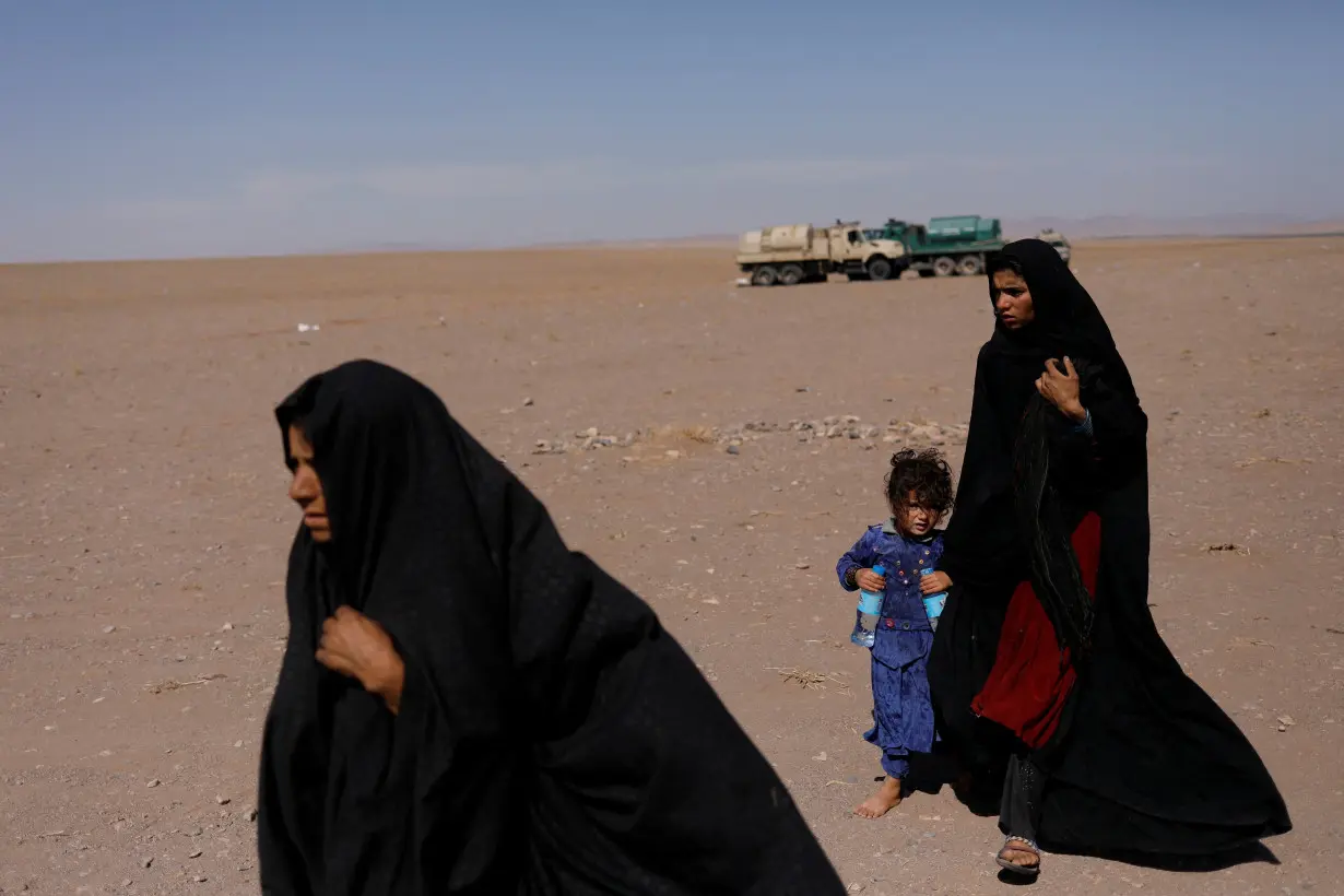 FILE PHOTO: Afghan women walk after the recent earthquake in the district of Zinda Jan, in Herat