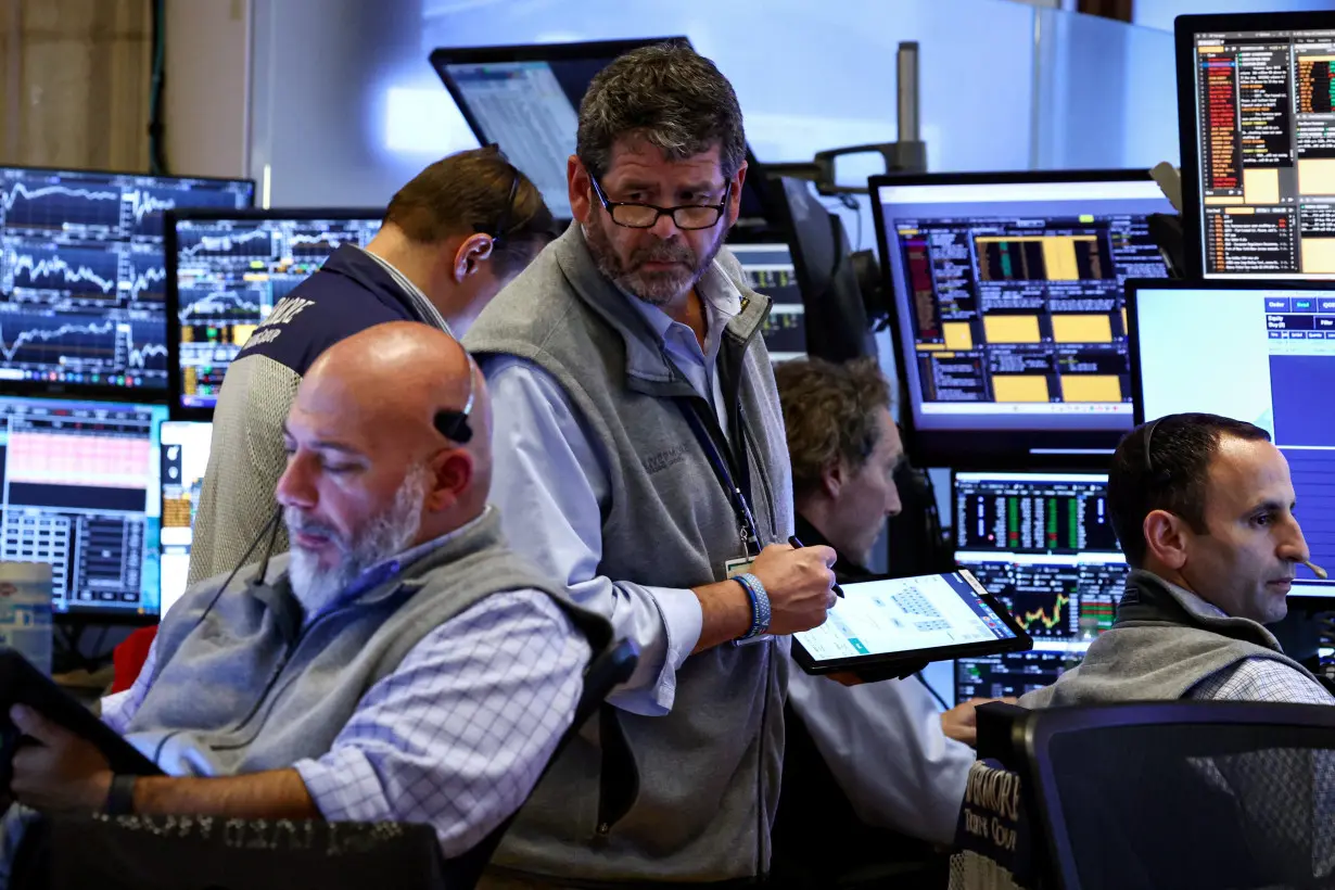 Traders work on the floor of the NYSE in New York